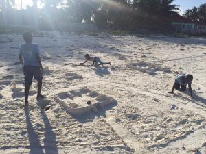 local children play on the beach.