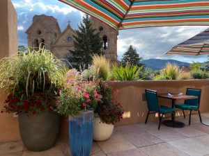 La Fonda rooftop restaurant with a view of the church and the mountains.